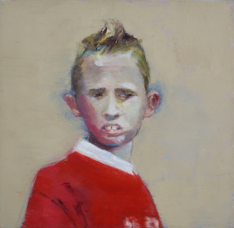 Portrait of young boy in red jersey